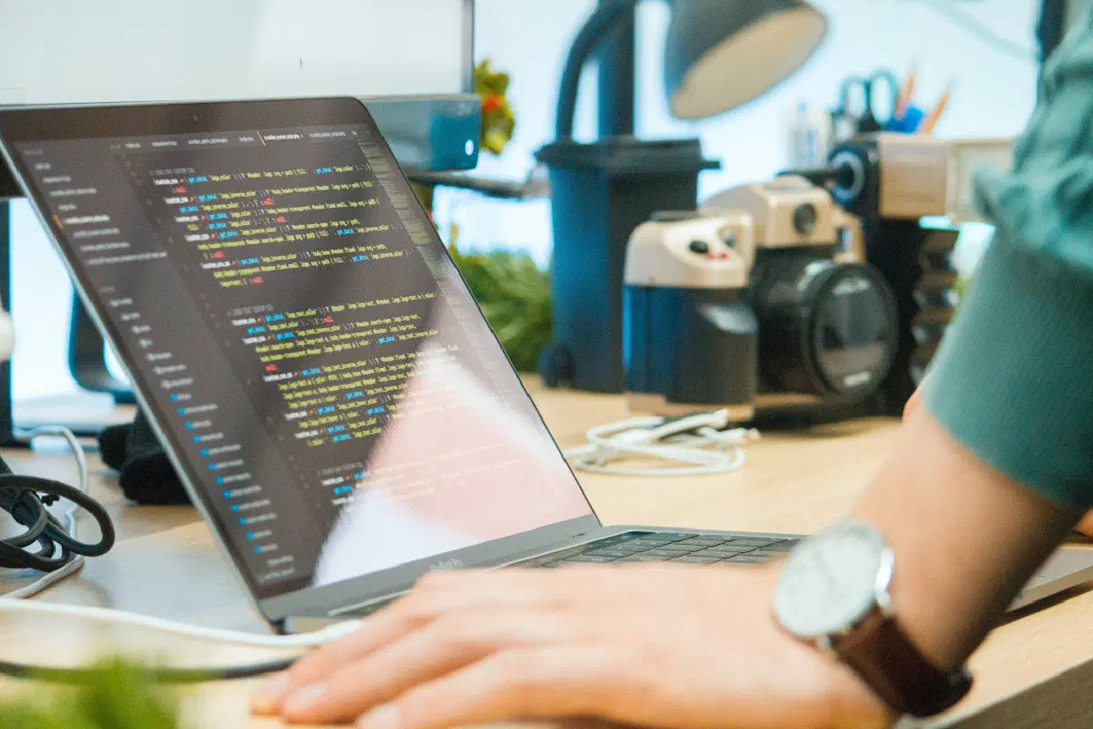 A photo of a person looking at code on a laptop computer. A photo of a person looking at code on a laptop computer.